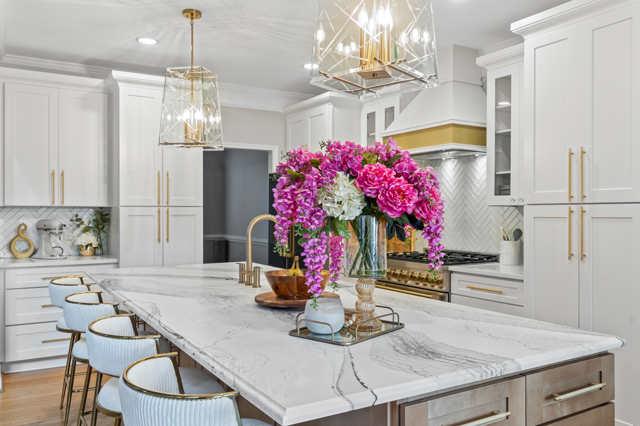 Haus of E kitchen with marble island and gold fixtures